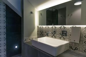 a bathroom with a white sink and a mirror at Smokvica Dorćol B&B in Belgrade +29 photos