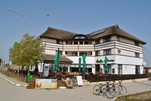 a building with two bikes parked in front of it at Delta Marina in Sfântu Gheorghe