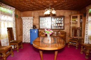 a room with a table with a vase of flowers on it at White House Group Of Houseboats in Srinagar