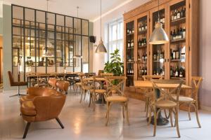 a restaurant with wooden tables and chairs in a room at Smokvica Dorćol B&B in Belgrade