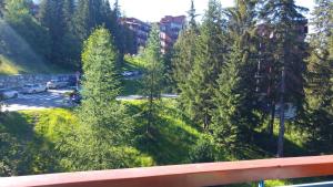 a view of a parking lot with trees at Le Vogel in Arc 1800