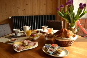 a table with food and drinks and flowers on it at Le Dahu in Chamonix