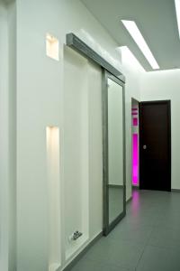a hallway with a mirror and a door in a building at Roma Naif Rooms in Rome