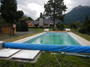 a swimming pool with a blue tarp around it at Sendero Lodge in Los Cipreses
