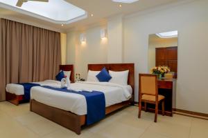 Tempat tidur dalam kamar di Tanzanite Executive Suites