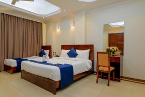 Säng eller sängar i ett rum på Tanzanite Executive Suites