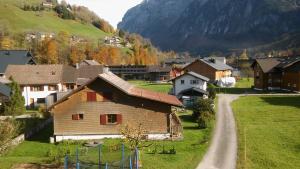 a small village with a house and a road at Studio Bergblick in Mellau