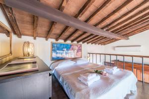 a bedroom with a large bed and a desk at Loggia panoramica in Florence