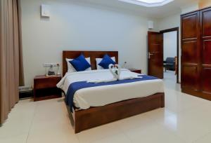 
a hotel room with a large bed and a large window at Tanzanite Executive Suites in Dar es Salaam
