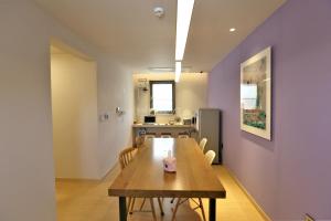 a kitchen and dining room with a table and chairs at Guest House Brick in Jeju