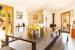 a dining room with a large wooden table at Le Ruone in Calcatoggio