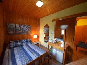 a bedroom with a bed and a wooden ceiling at Christys Palace Hotel in Pedoulas
