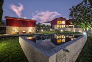 a house with a swimming pool in the yard at Quintãs Farm Houses in Arouca +30 photos