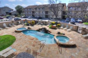 a swimming pool in a courtyard with a building at Windrow Retreat in New Braunfels