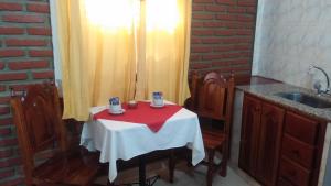 a small table with a red and white table cloth at Apart Termal San Ramon in Termas de Río Hondo