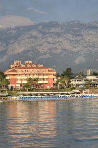 a large building on the shore of a body of water at Valeri Beach Hotel in Kemer