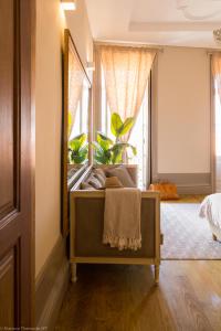 a bedroom with a mirror and a bed with plants at Romantic - Casa Rua Bela in Porto