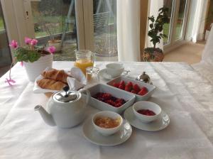 a table with a tea set with fruit and croissants at Shakespeare's View in Stratford-upon-Avon