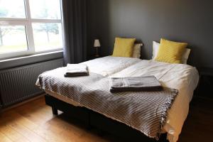 a bedroom with a bed with two towels on it at Ármót Guesthouse in Hvolsvöllur