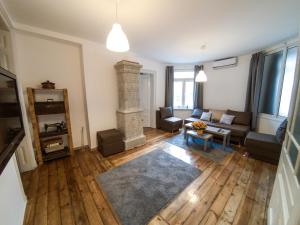 a living room with a couch and a fireplace at Graf Ignatiev - 3BR APART in Sofia