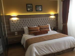 Ένα ή περισσότερα κρεβάτια σε δωμάτιο στο De Película Hotel