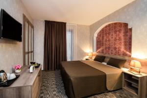 a hotel room with a bed and a television at Old Side Boutique Hotel in Tbilisi City