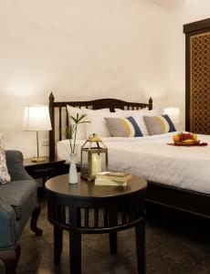 a hotel room with a bed and a table at Thai Akara - Lanna Boutique Hotel -SHA Extra Plus in Chiang Mai
