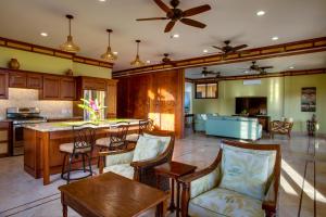 a kitchen and living room with a table and chairs at Villa Margarita at Jaguar Reef in Hopkins