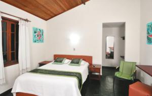 En eller flere senge i et værelse på Pousada Vistamar