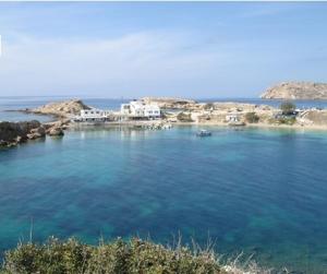 a large body of water with buildings in the background at Sea Melody in Lefkos Karpathou
