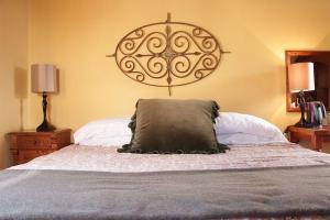a bedroom with a bed with a pillow on it at Hotel El Real in Real de Catorce