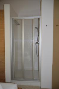 a shower with a glass door in a bathroom at Haus Christine in Neukirchen am Großvenediger