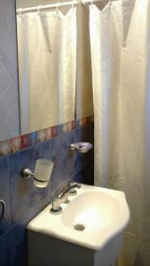 a bathroom with a sink and a mirror at El Mundo Interior in Capilla del Monte