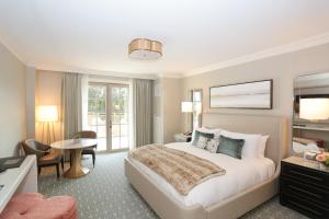 a hotel room with a bed and a desk at Delamar West Hartford in West Hartford