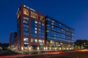 a large building with lights in front of a street at The Hotel at the University of Maryland in College Park