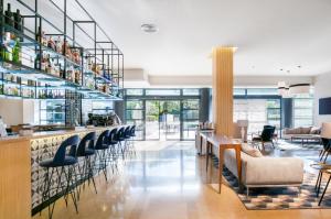 a restaurant with a bar with chairs and tables at Exe Madrid Norte in Madrid