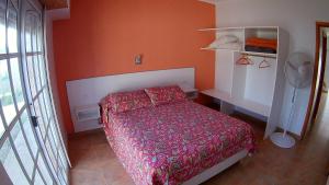 a bedroom with a red bed in a room at Alquileres Relax11sanclemente in San Clemente del Tuyú +96 photos
