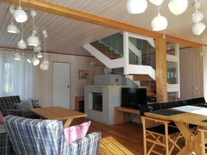 a living room with a dining table and a staircase at Marina Holiday Lotus Village in Imatra