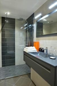 a bathroom with a sink and a shower at Hôtel d'Argouges in Bayeux