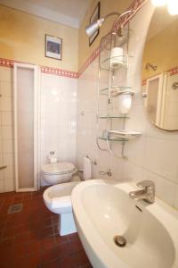a bathroom with a sink, toilet and tub at La Bussola Da Gino in Quarrata