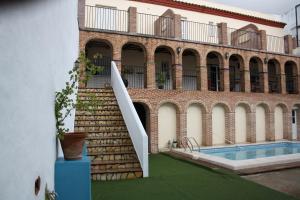 a staircase leading to a building with a swimming pool at Casa Rural Sidonia in Medina Sidonia
