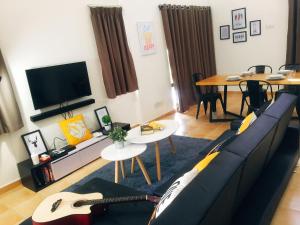 a living room with a couch and a guitar in it at Luxury Villa @ A'F Resort in Melaka