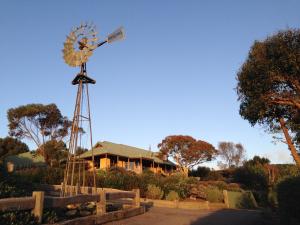 a large white building with a clock on top of it at Daysy Hill Country Cottages in Port Campbell