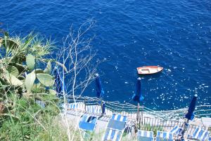 a boat in the water with chairs in the ocean at Bed and Breakfast Da Claudio in Conca dei Marini +19 photos