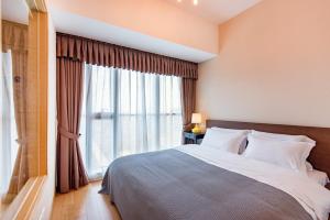 Postel nebo postele na pokoji v ubytování S6 Service Apartment（Chengdu Chunxi Road Taikoo Li Branch）