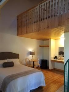 a bedroom with a large bed and a staircase at Lenroot Lodge in Seeley