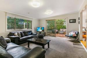 a living room with a couch and a table at Bonnie Blairgowrie in Blairgowrie