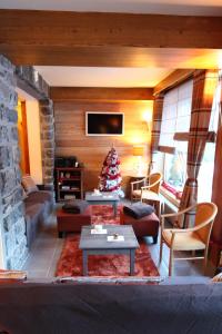 a living room with a christmas tree in it at La Maison Rapin in Valloire