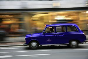 a small blue car driving down the street at 137 Pillars Residences Bangkok in Bangkok
