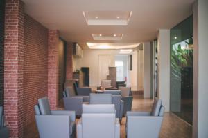 a waiting room with chairs and a brick wall at The Wings Boutique Hotels Krabi Ko Lanta in Ko Lanta